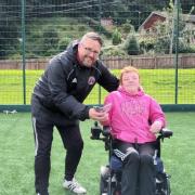 Darren Thomson hands over donation to Graeme McIver on behalf of GFR Para Disability squad