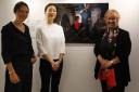 Photographer Olivia Harris (left) pictured with Deputy Presiding Officer Christine Grahame MSP  (right) and World Press Photo curator Yi Wen Hsia (centre).  They are pictured beside the World Press Photo winner 2019, which shows a crying child at the Mexi
