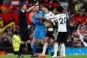 Aleksandar Mitrovic, centre, has been charged with violent conduct after grabbing referee Chris Kavanagh at Old Trafford (Martin Rickett/PA)
