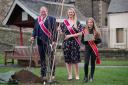 Peebles Cornet 2022, Iain Mitchell, Cornets Lass 2022 Becca Lumsden and Beltane Queen 2022 Elena Chrystie at the planting of a tree from the Queen Elizabeth Platinum Jubilee Green Canopy on Tweed Green, Peebles. Photo: Peebles Beltane Festival