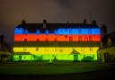 Traquair House lit with the UCI Cycling World Championships rainbow - blue, red, black, yellow, and green - to celebrate six months until event