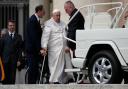 Pope Francis is helped to get on his ‘popemobile’ at the end of weekly general audience in St Peter’s Square (AP Photo/Alessandra Tarantino)