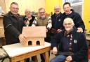 Finishing a covered bird feeding tray are Biggar Shed members, left to right: Lindsay Moffat, treasurer Ian Veale, MP David Mundell, Richard Crosse, chair Ranald McGregor and fund-raising co-ordinator Phil Cave. Photo: Bryan Armstrong