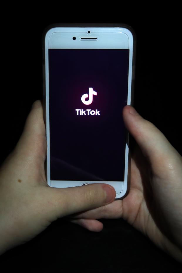 Peeblesshire News: A person with TikTok open on their phone. Credit: PA
