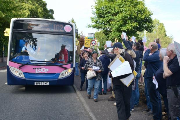 Peeblesshire News: Protestors in West Linton as a 102 bus arrived. Photo: Mark Davey.