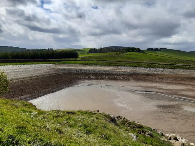 Peeblesshire News: The drained reservoir. Photo: Scottish Water