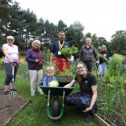 Andy Entwistle will be raising money for Peebles CAN Garden at this year's Kilt Walk. Pictured with ith Heather Mackay and Nichole Dow of Peebles CAN, one-and-a-half-year-old James Dow, and garden volunteers. Photos: Helen Barrington