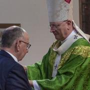 Douglas Turnbull receives the Benemerenti Medal (Papal Medal) in recognition of his 50 years, from Archbishop Leo Cushley at the weekly Mass. Photo Lorna Fleming