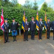Legion Standard bearers at Dryburgh with Alasdair Hutton (centre), piper Alastair Currie (second left) and Parade Marshal Graham Walter (right)