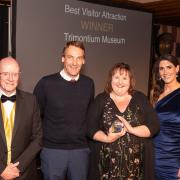 Rob Longworth and Frances Mann (centre) of the Trimontium Trust, with Best Visitor Attraction award presenter Prof Russel Griggs OBE and awards host Lori Carnochan. Photo: Phil Wilkinson