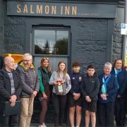 Ceremonial ribbon cutting at Salmon Inn to mark installation of a new defibrillator