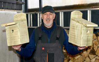 Jim Mcalpine with two of his hand made bird boxes. Photo: Mark Davey